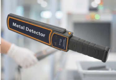 Security officers using affordable handheld metal detectors at an event entrance in Nigeria